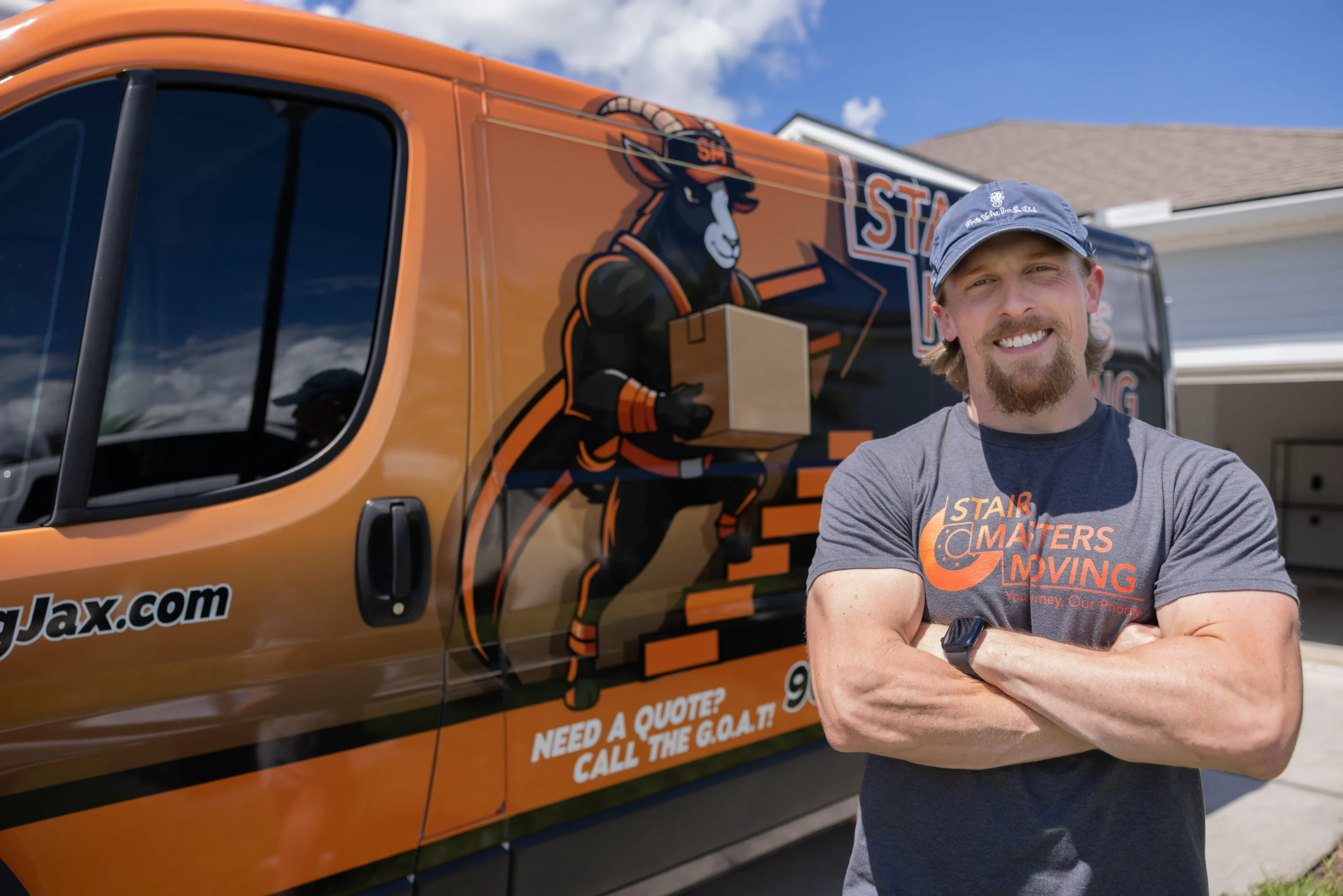 Stair Masters Moving owner Tyler standing in front of the branded moving van